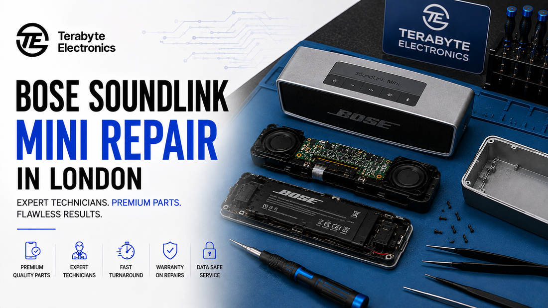 Internal teardown view of a disassembled Bose SoundLink Mini Bluetooth speaker showing transducers, passive radiators, power PCB, and aluminum housing on a blue ESD mat at Terabyte Electronics Kilburn.